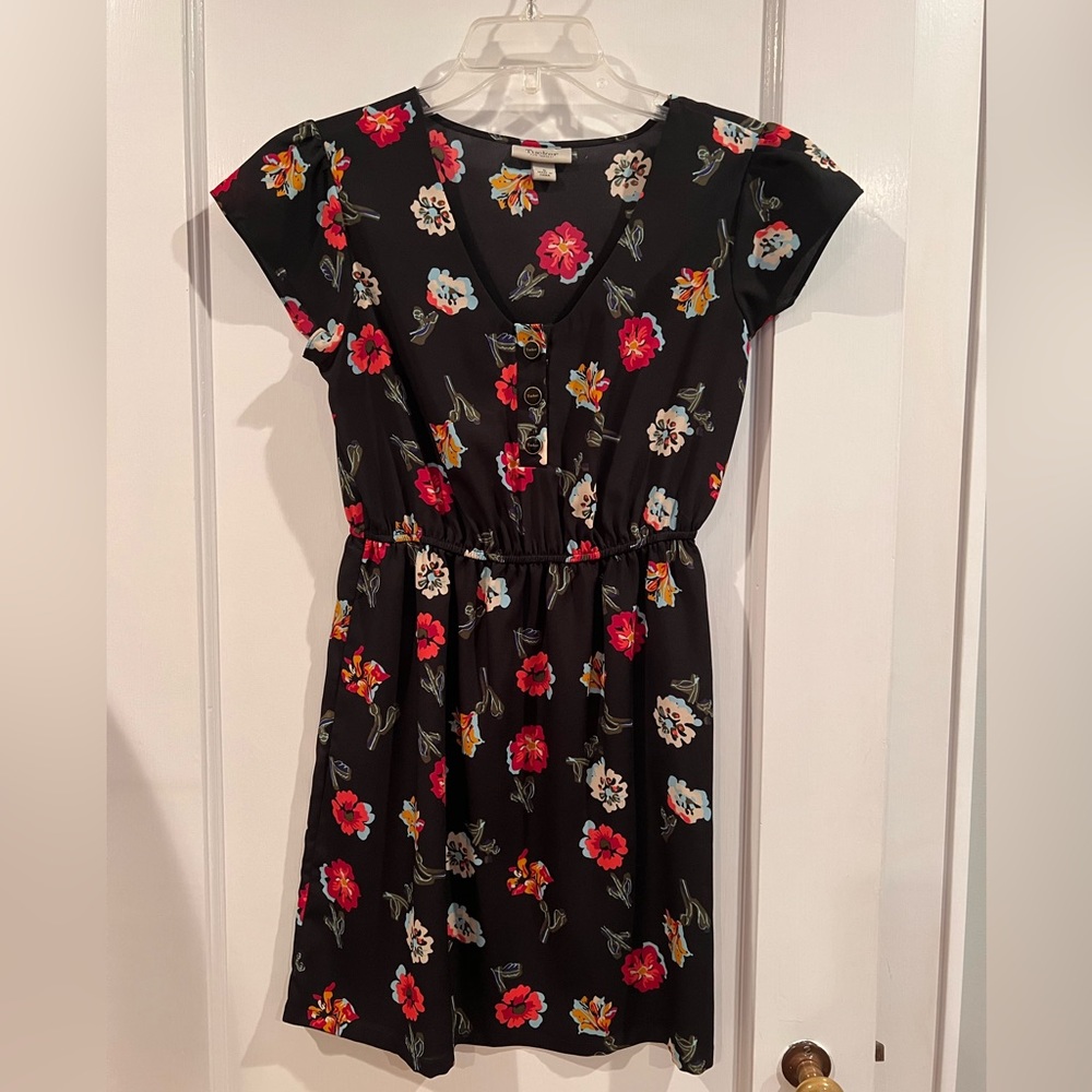 Dress by Tucker. Black with floral pattern.